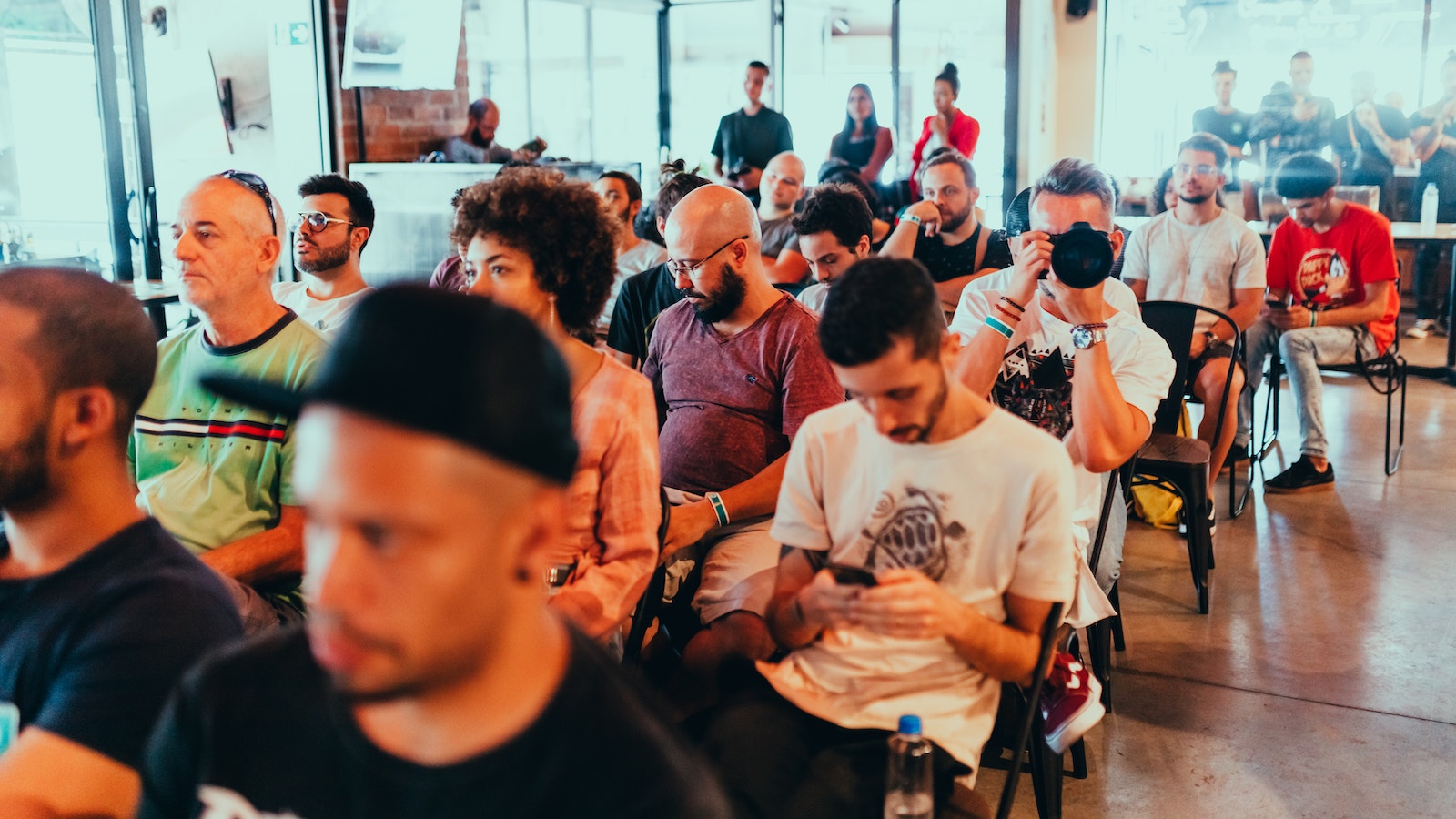 Photo Of People Sitting On Chairs